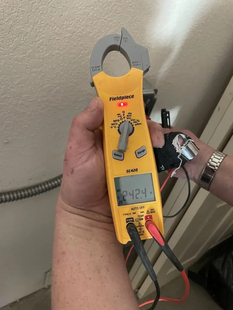 Voltage testing with clamp meter during Whole House Surge Protector in West Liberty
